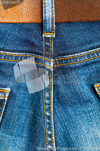 Image of ol blue denim with seams and leather belt 