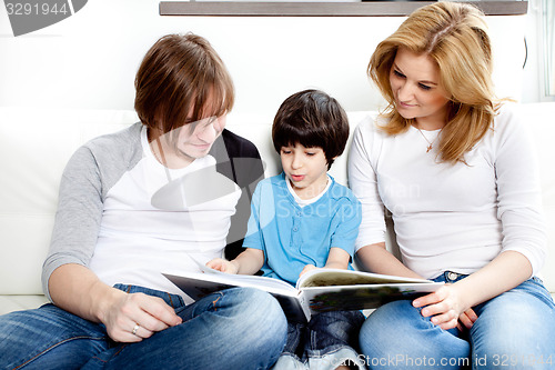 Image of Portrait of friendly family reading book