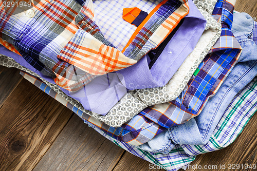 Image of summer bright shirts in a pile