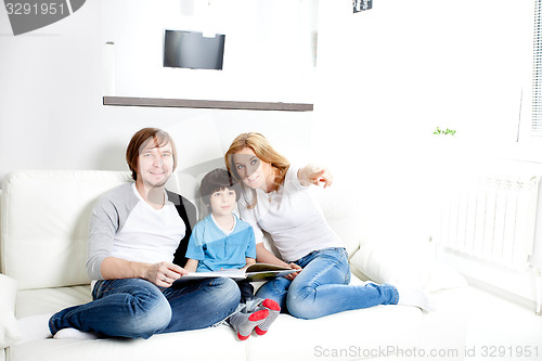 Image of Portrait of friendly family reading book