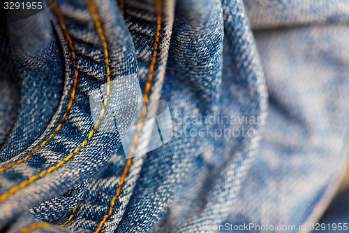 Image of blue Jeans with yellow stitching thread