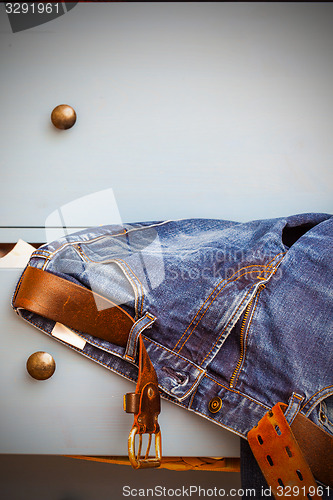 Image of jeans sticking out of a drawer