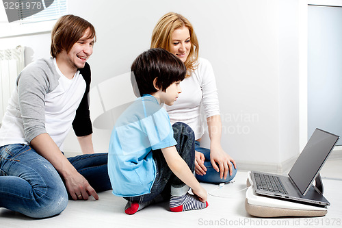 Image of Young parents with child