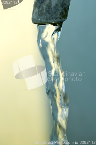 Image of Tap of running water isolated on grey background