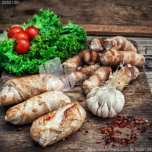 Image of set fried meat sausages on wooden background