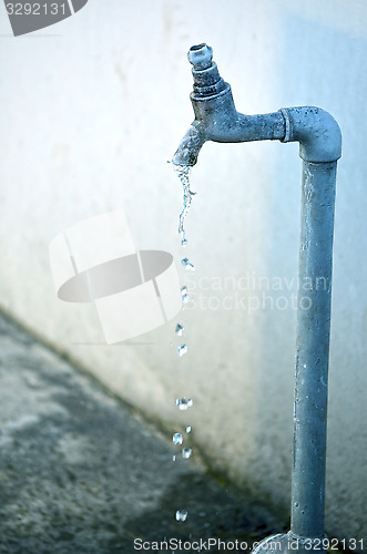 Image of Tap of running water isolated on grey background