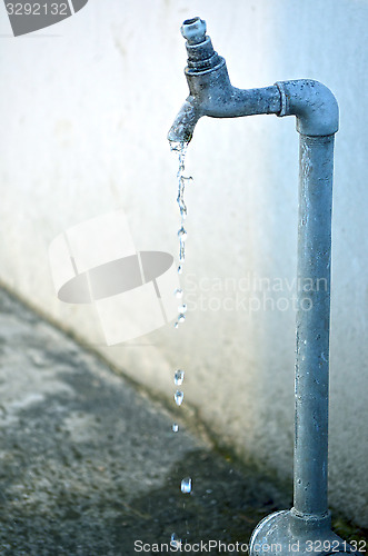 Image of Tap of running water isolated on grey background