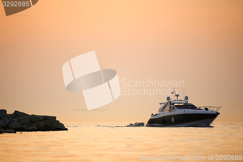 Image of Boat with dinghy in sea