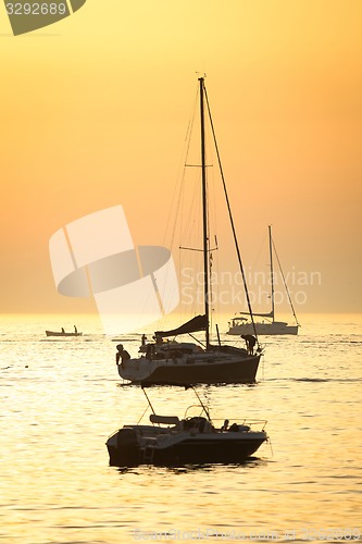 Image of Boats sailing at sunset