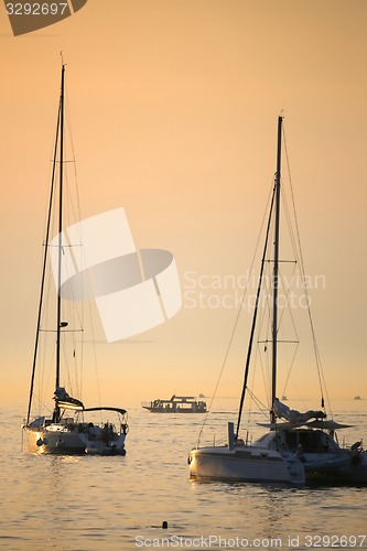 Image of Anchored boats at sunset