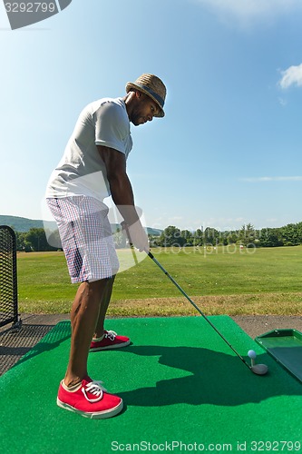 Image of Golfer Teeing Up at the Driving Range