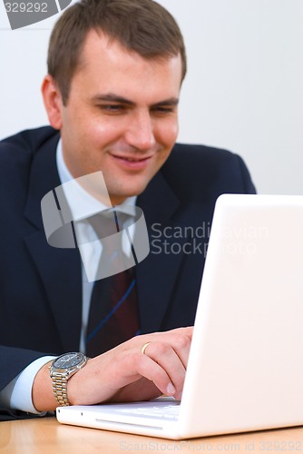 Image of Young businessman working on a lap-top