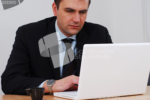 Image of Businessman working on white computer