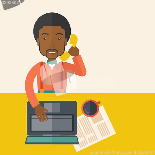 Image of African Office man sitting at his working desk.