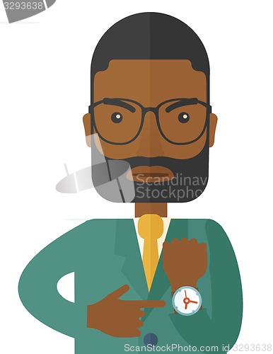 Image of Black man is angry pointing his watch.