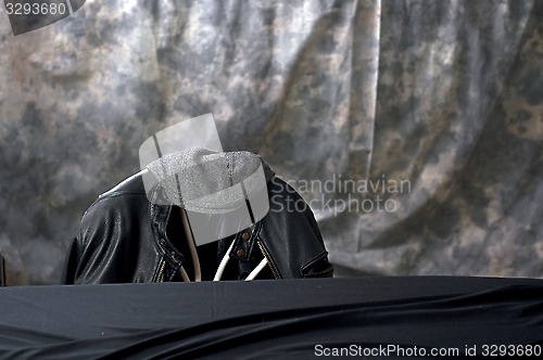 Image of black leather jacket and cap