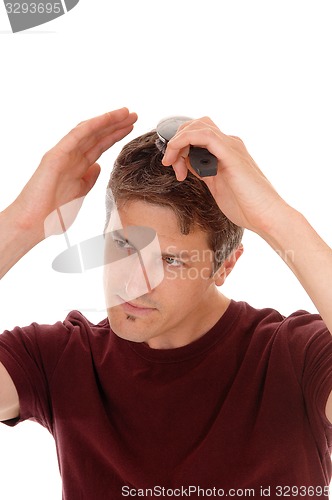 Image of Man brushing his hair.
