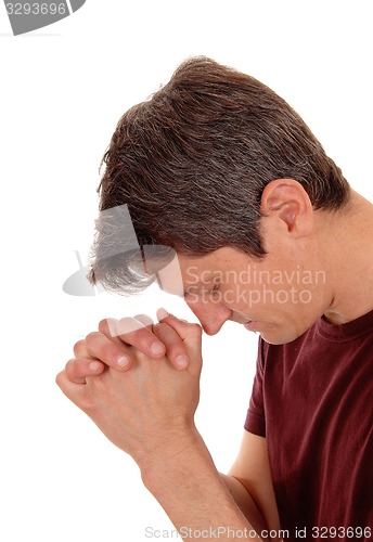 Image of Praying young man in profile.