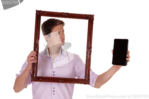 Image of Man looking trough picture frame.