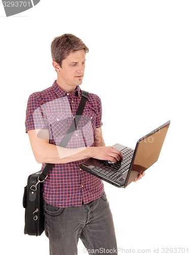 Image of Standing man with laptop.