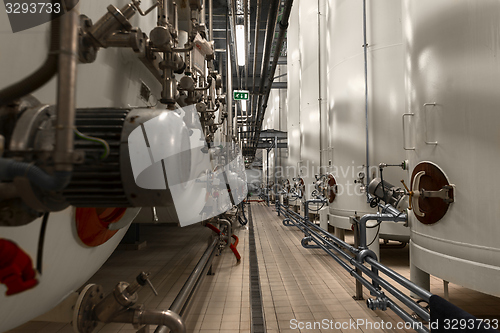 Image of Large industrial white silos in modern factory