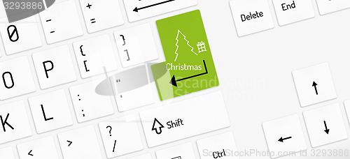 Image of white keyboard, christmas tree and gift
