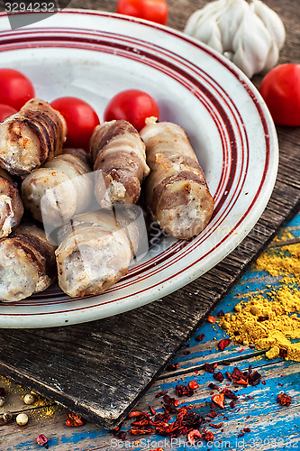 Image of set fried meat sausages on wooden background