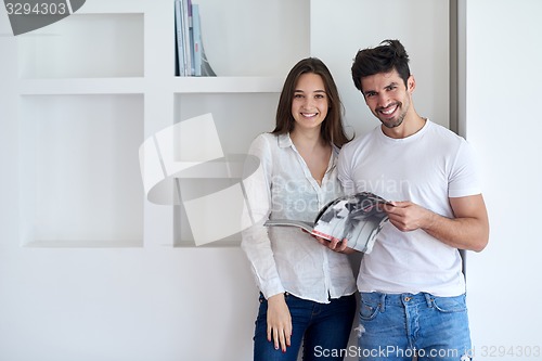 Image of relaxed young couple at home staircase
