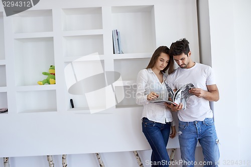 Image of relaxed young couple at home staircase