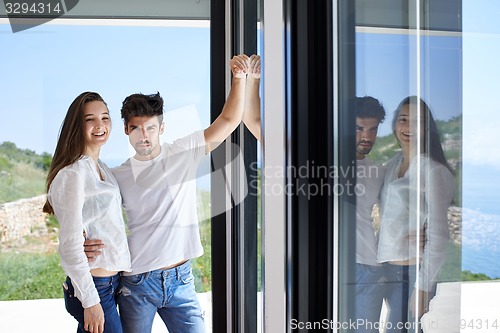 Image of relaxed young couple at home staircase