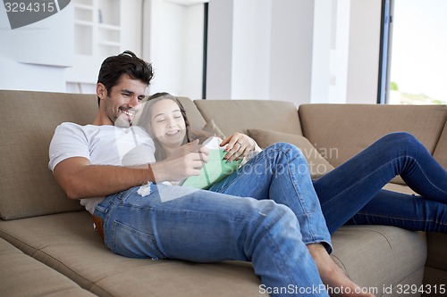 Image of couple at modern home using tablet computer