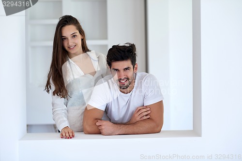 Image of relaxed young couple at home staircase
