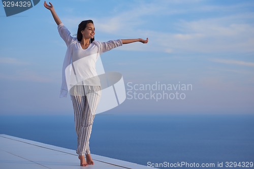 Image of young woman enjoy sunset