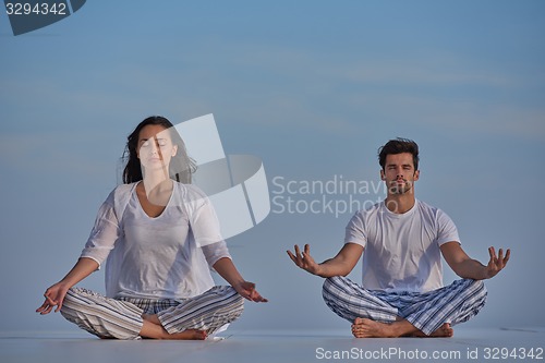 Image of young couple practicing yoga