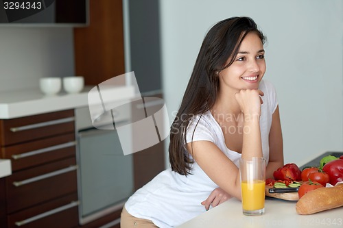 Image of Young Woman Cooking in the kitchen