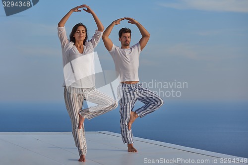 Image of young couple practicing yoga