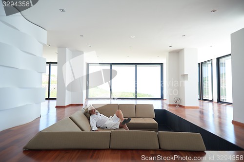 Image of Portrait of senior man relaxing in sofa