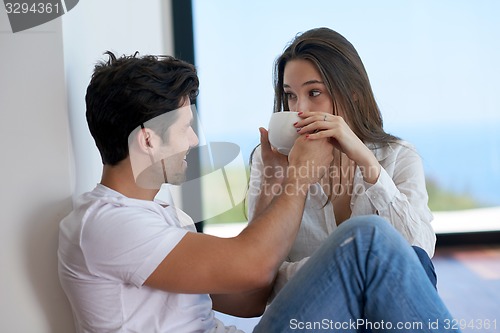 Image of relaxed young couple at home staircase