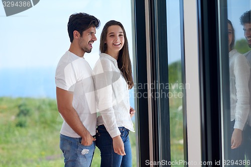 Image of relaxed young couple at home staircase