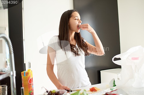 Image of Young Woman Cooking in the kitchen