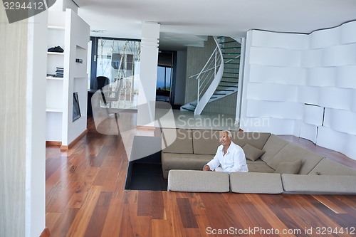 Image of Portrait of senior man relaxing in sofa