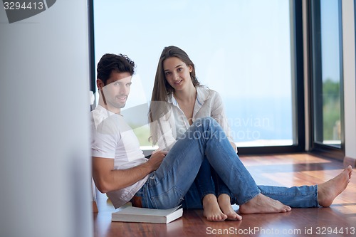 Image of relaxed young couple at home staircase