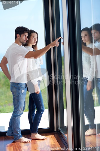 Image of relaxed young couple at home staircase