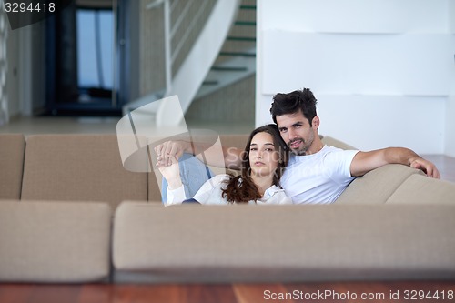 Image of relaxed young couple at home staircase