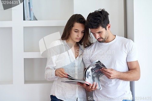 Image of relaxed young couple at home staircase