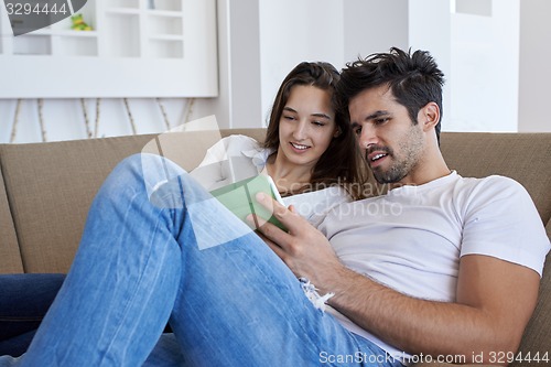 Image of couple at modern home using tablet computer