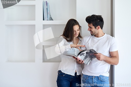 Image of relaxed young couple at home staircase