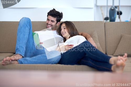 Image of couple at modern home using tablet computer