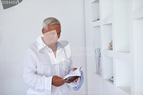 Image of Portrait of senior man relaxing in sofa