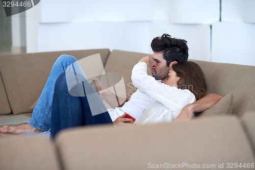 Image of couple at modern home using tablet computer